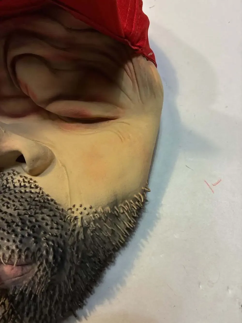 Realistic Man with Beard and Cigarette Latex Novelty Mask with Red Cap